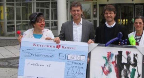 Robert Ketterer (Mitte links) übergibt den KlinikClowns gemeinsam mit Dipl.-Ing. Bernd Sacher, dem glücklichen Sieger des Bietgefechts der Online-Auktion (Mitte rechts), einen Scheck mit der erlösten Summe von € 6.002