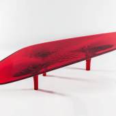 Lot 23 Zaha Hadid Liquid Glacial Colour Coffee Table acrylic 15 3/4 by 106 1/4 by 35 3/8 in. 40 by 270 by 92.5 cm. Executed in 2012, this work is the only red version produced from the edition of 8, plus 2 prototypes and 2 artist's proofs with David Gill Gallery.  Estimate $100/150,000 Sold for $300,000
