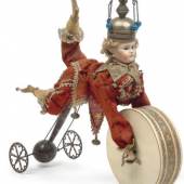Harlekin mit Porzellankopf aus der Zeit um 1880, der, wird er gezogen, die Beine auf und ab bewegt und die Trommel rollt, wurden 3.750 Euro geboten (Kat. Nr. 176)