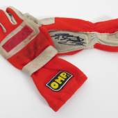 Nr. 28 Ferrari "OMP" Rennhandschuhe/Racing Gloves" von Michael Schumacher signierte OMP Rennhandschuhe, Innenfutter beschriftet und datiert: G. P. Spain 02.06.96, beide Handflächen vom 7-fachen Weltmeister signiert und datiert 1996, Handrücken mit verwaschener Signatur OMP-Aufnäher, gebraucht, guter Zustand Startpreis € 600