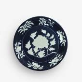 Lot 6 Property of a Gentleman An Exceptionally Rare and Large Fine Blue and White Reserve-Decorated ‘Peony’ Dish Xuande Mark and Period Diameter 15 1/4 in., 38.6 cm Estimate $1/1.5 million Sold for $ 2,172,500