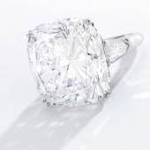 Lot 57 An Impressive Diamond Ring, Harry Winston Set with a cushion-cut diamond weighing 51.52 carats, flanked by two shield-shaped diamonds Estimate $3.5/4.5 million