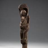 An Old Grade Society Statue. New Hebrides, Vanuatu.
Fern-tree. Carved tree fungus with original tree-trunk still evident. Of cylindrical overall form with large head at top, sculptured elongated chin, slit mouth, large nose under arched and overhanging brow. Arms carved at sides with hands resting on the abdomen. Short bent legs standing on cylindrical base