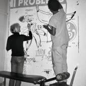 Andy Warhol and Jean-Michel Basquiat working on a Collaboration painting in Warhol’s Manhattan loft, 1984. Art © 2024 Andy Warhol Foundation for the Visual Arts / Artists Rights Society (ARS), New York 