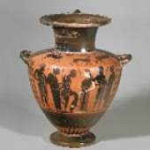 Black- figure hydria by the Ready Painter. The main scene shows a man arming, his left leg lifted as he pulls on his greave. Facing him is a woman supporting his spear. The two main figures are flanked by four other men three of whom carry spears and two of whom are wrapped in the himation. The shoulder zone shows a panther facing right between two grazing deer. At the top a band of tongues and at the lower body a band of rays. Athens, 520 - 510 BC. 12.1 ( 307 mm). Intact.