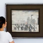 L.S. Lowry, Going to the Match, 1928, oil on canvas 17 by 21in. (est. £2,000,000-3,000,000) - in situ