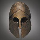 Lot 5 A Greek Bronze Helmet, circa late 6th Century B.C.