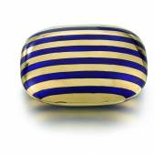 Lot 283 VIVIEN’S POWDER COMPACT enamel, glass the exterior applied with stripes of blue enamel, the hinged lid opening to reveal a mirror and powder compartment. Estimate £1,500-2,000