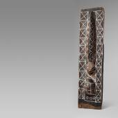 AN NKANU INITIATION PANEL  Angola/Democratic Republic of the Congo  From a kikaku initiation hut, the slender rectangular panel carved in high relief with a viper facing a tortoise, painted all over with geometric design in various colors.  Schätzpreis: €10.000 - €15.000  