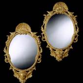 A pair of George II oval giltwood mirrors.  English, circa 1740. Height: 48 in; 122 cm Width: 31 1/4 in; 79.5 cm