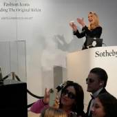 Auction officer Aurélie Vandevoorde gestures as the original Birkin bag created by Hermès for Jane Birkin was sold at auction. (Source: Associated Press)