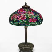 Lot 34 Property From The Collection Of David And Lindsay Morgenthaler, Cleveland, Ohio Tiffany Studios "Peony" Table Lamp with a telescopic "Chased Pod" library standard base shade impressed TIFFANY STUDIOS NEW YORK 1505-36 base impressed 9933/TIFFANY STUDIOS/NEW YORK with the Tiffany Glass and Decorating Company monogram leaded glass and patinated bronze  32 1/2  in. (82.6 cm) high as shown 22 in. (55.9 cm) diameter of shade circa 1910 Est. $180/240,000 Sold for $ 225,000
