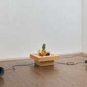 Yuko Mohri, Decomposition, 2023, seasonal fruits, wooden pedestal, computer, audio, speaker. Courtesy the artist and Yutaka Kikutake Gallery 
