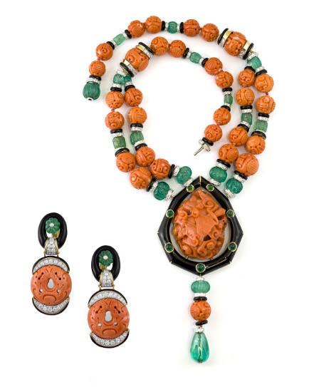 Necklace and earrings, in yellow gold 18K, carved coral, diamonds and emerald with black enamel Courtesy of David Webb, New York
